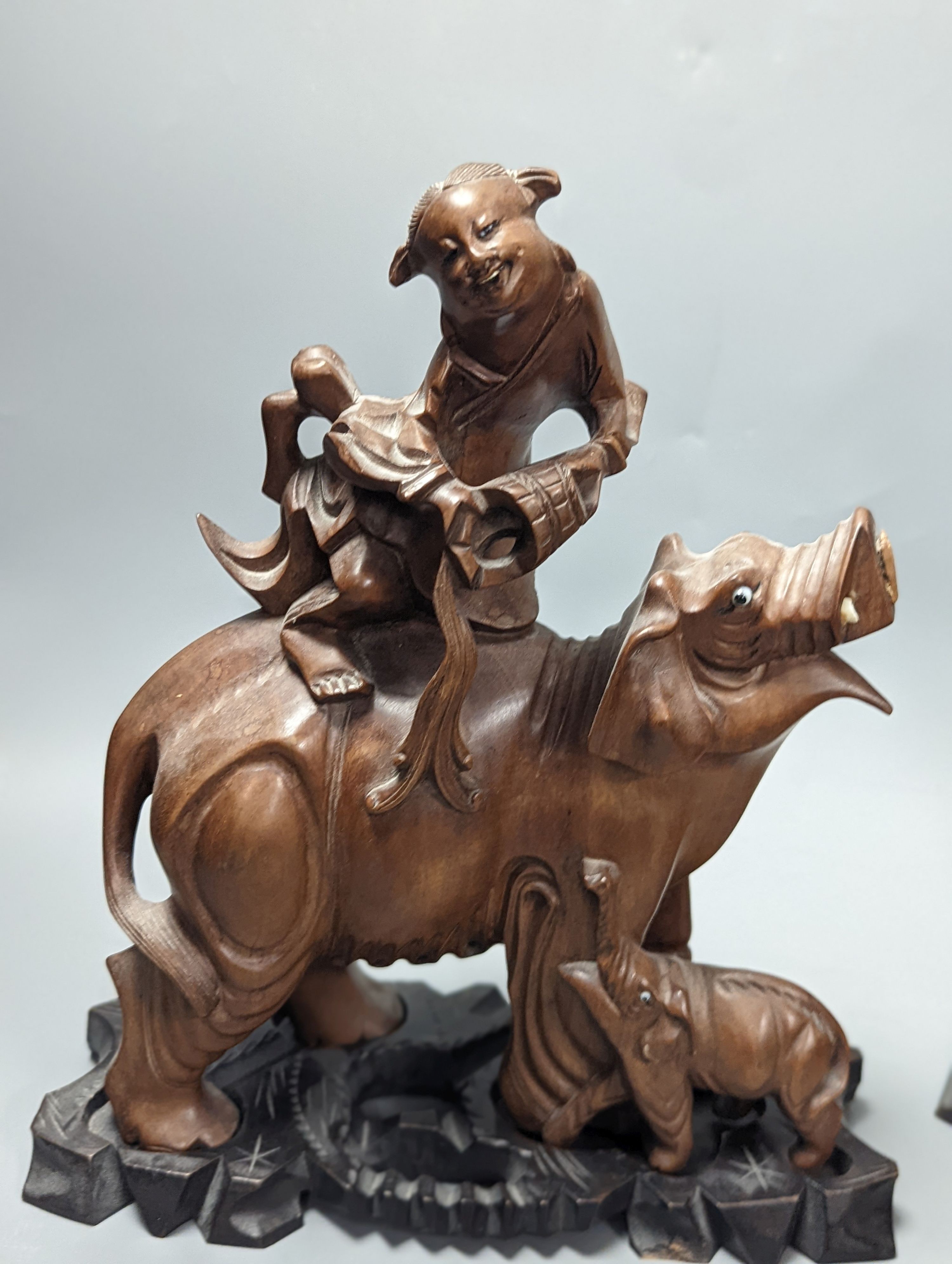 A pair of Chinese wood carvings figures on elephants, a pair of Chinese bear bookends, Chines figures 26 cms high.